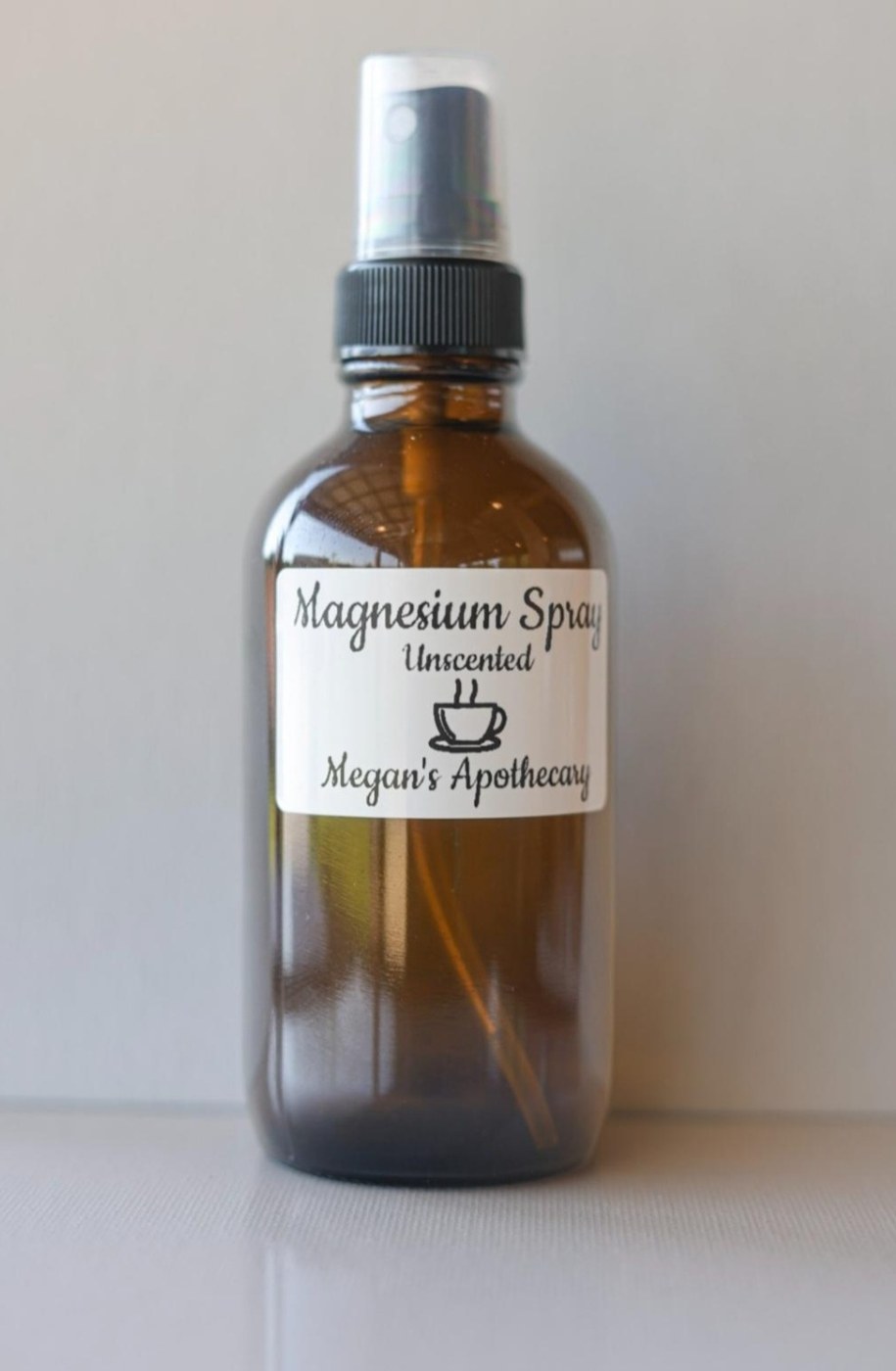 An amber spray bottle of unscented magnesium spray