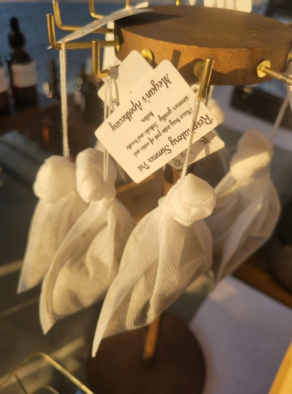 Muslin sachets of Respiratory Simmer Pot hanging on a stand